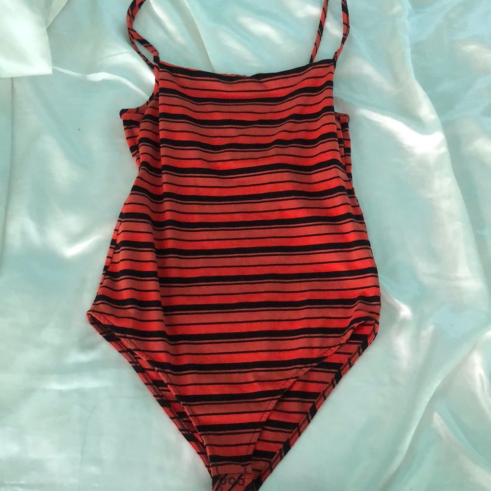 Orange and black body suit